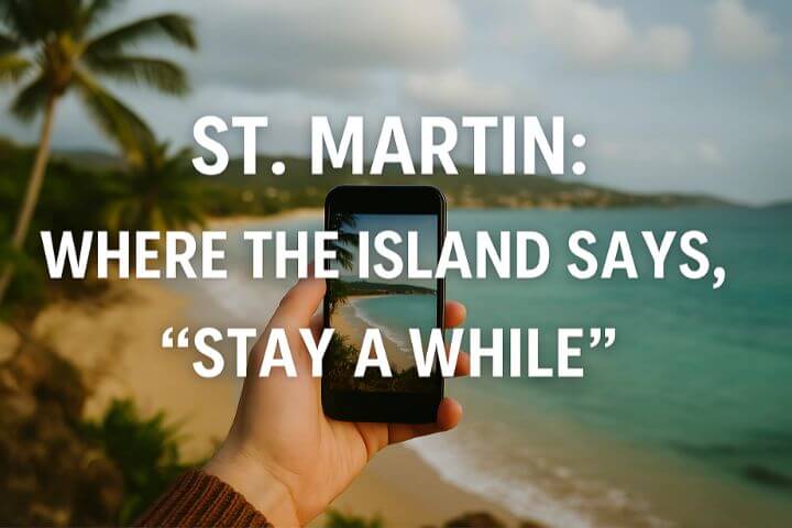 5 Reasons I Fell in Love -This image features a scenic beach setting on the island of St. Martin. In the foreground, someone is holding up a smartphone, capturing the picturesque shoreline, palm trees, and ocean. The phone screen displays the same beach view, aligning perfectly with the real scene behind it.